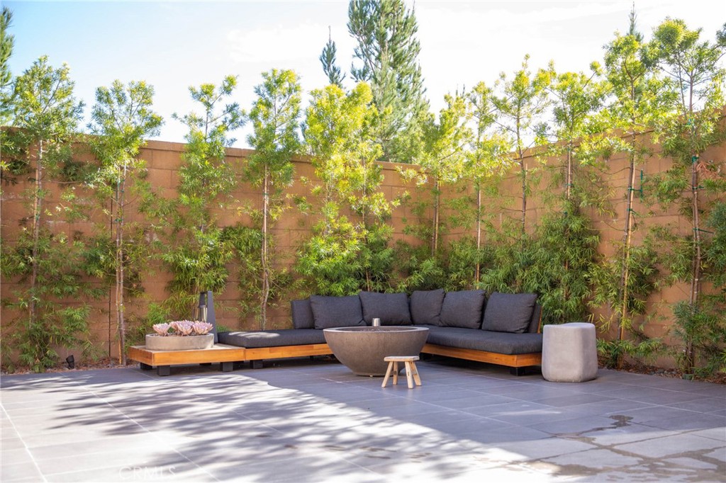 119 Wheatgrass Irvine, CA 92618 - Photo 25 of 32 a backyard of a house with couches and wooden fence