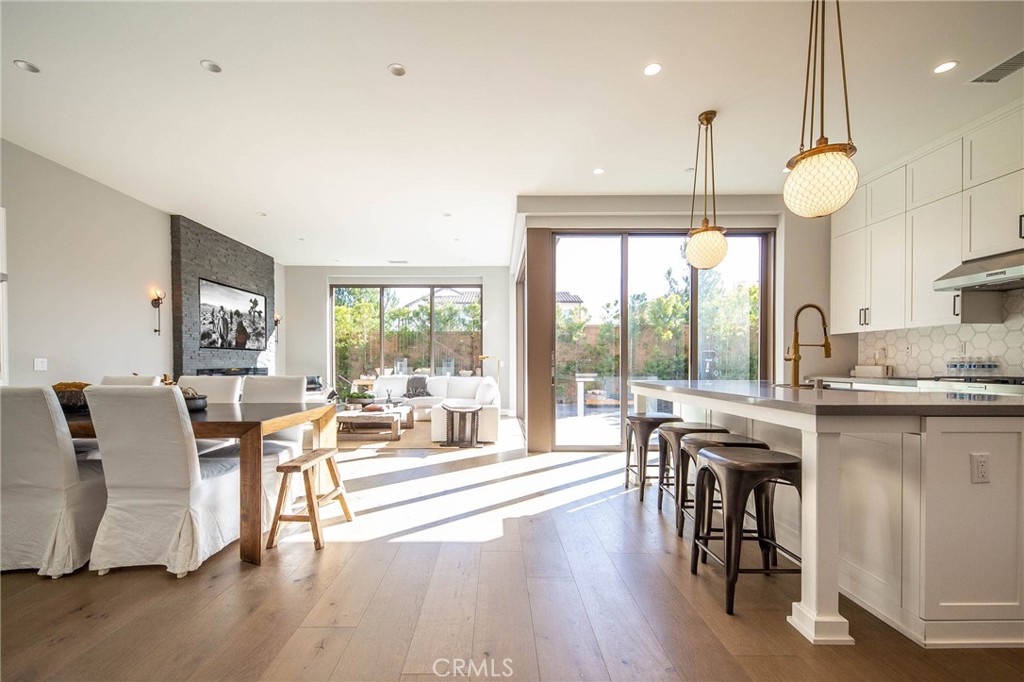 119 Wheatgrass Irvine, CA 92618 - Photo 3 of 32 a living room with furniture a wooden floor and a large window