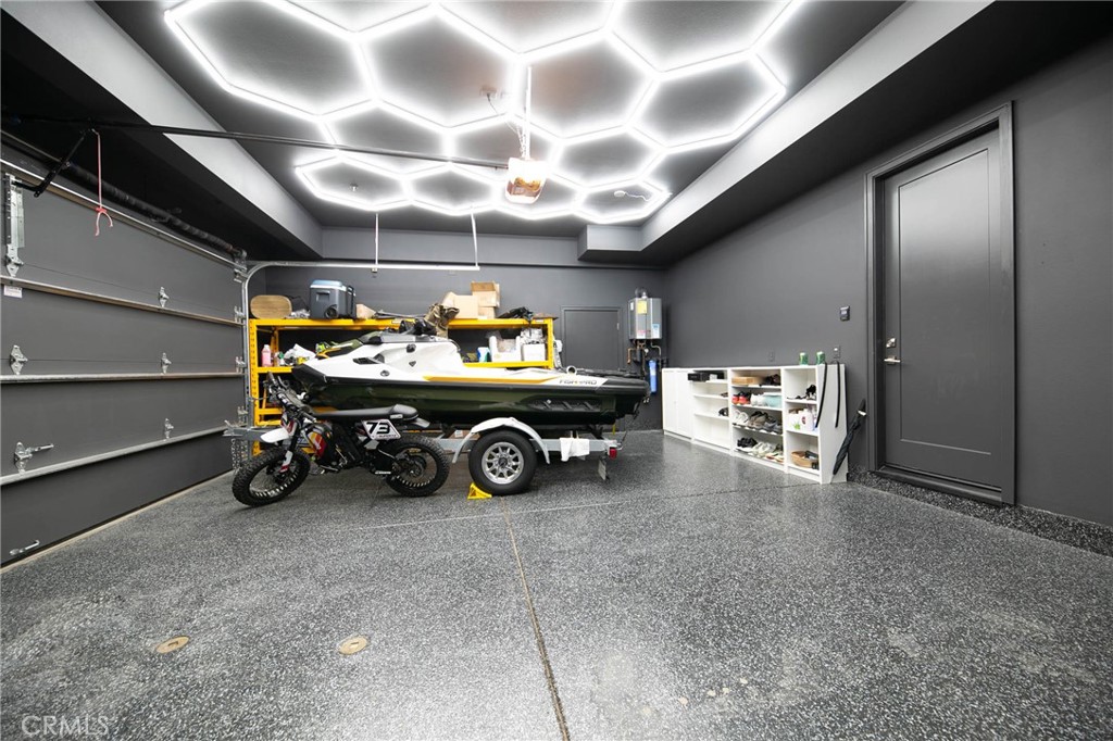 119 Wheatgrass Irvine, CA 92618 - Photo 32 of 32 a garage with a car and a chandelier