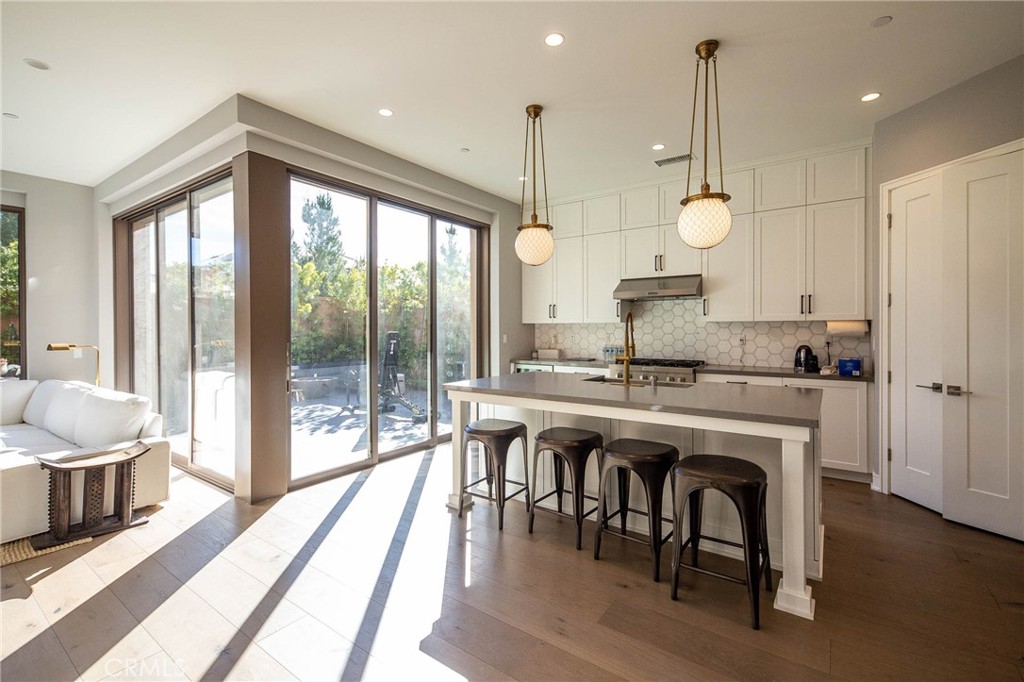 119 Wheatgrass Irvine, CA 92618 - Photo 5 of 32 a open kitchen with a table and chairs