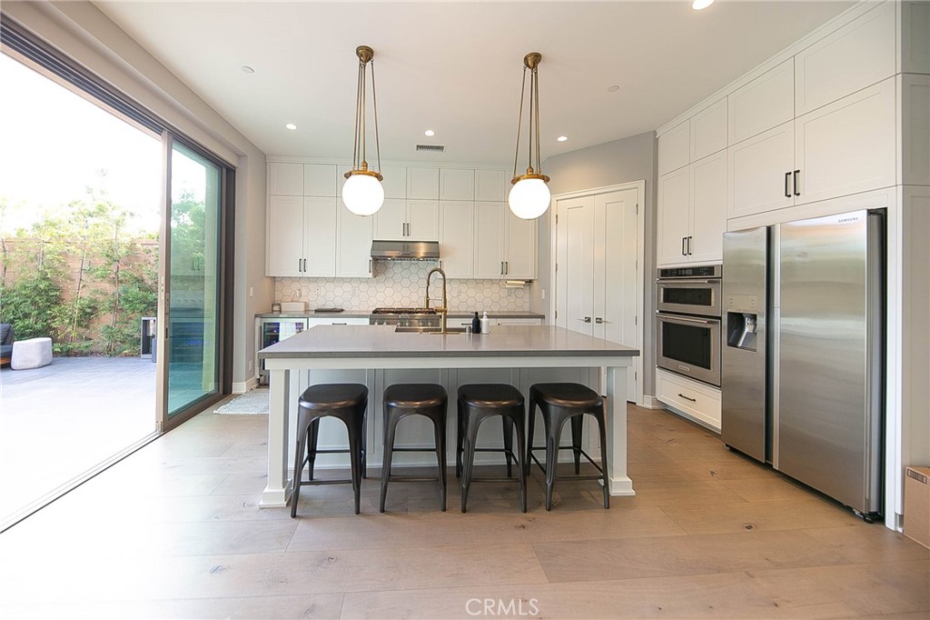 119 Wheatgrass Irvine, CA 92618 - Photo 7 of 32 a kitchen with a table and chairs