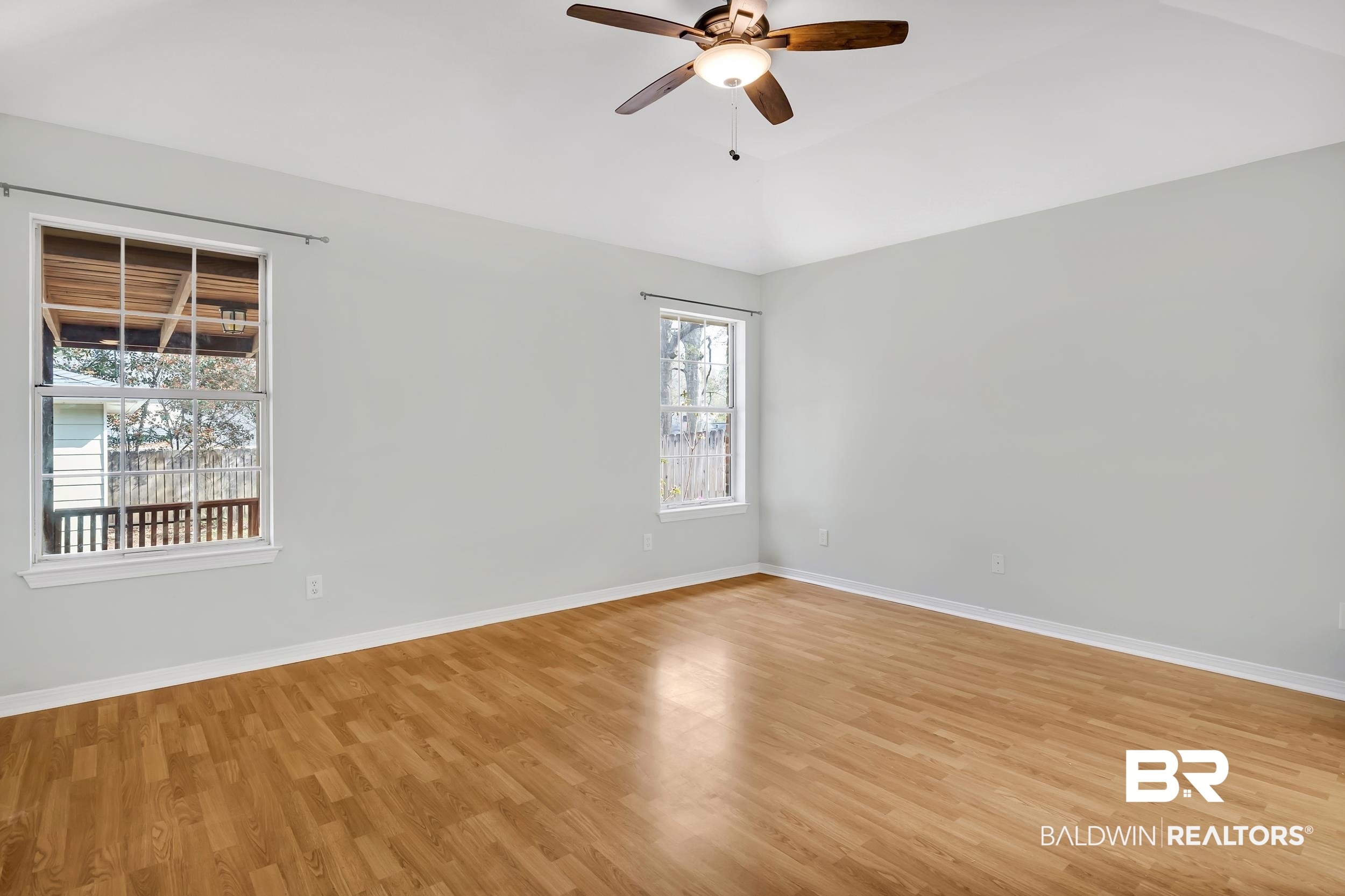 6616 Conde Court Mobile, AL 36695 - Photo 16 of 27 Spare room featuring vaulted ceiling, a ceiling fan, baseboards, and light wood finished floors