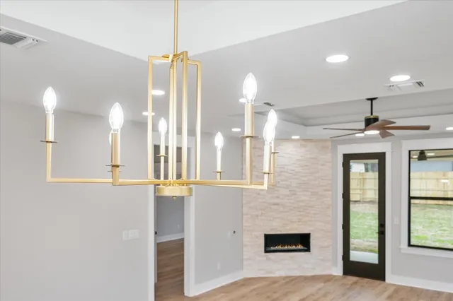 a large kitchen with kitchen island white cabinets and stainless steel appliances
