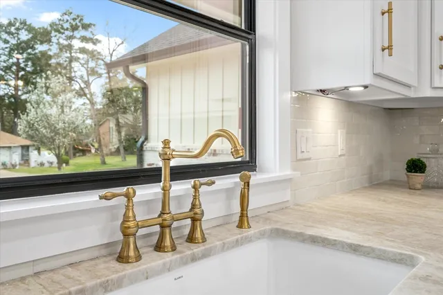 a kitchen with granite countertop a stove a sink and a refrigerator