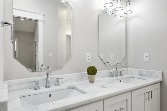a bathroom with a double vanity sink and a mirror