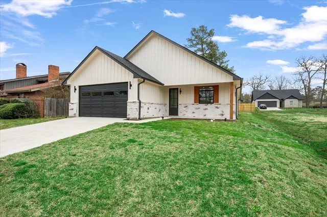 a front view of house with yard and green space