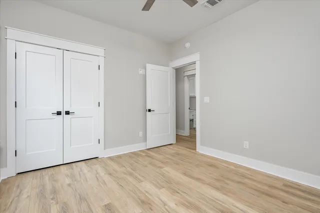 a view of a livingroom with a ceiling fan and window