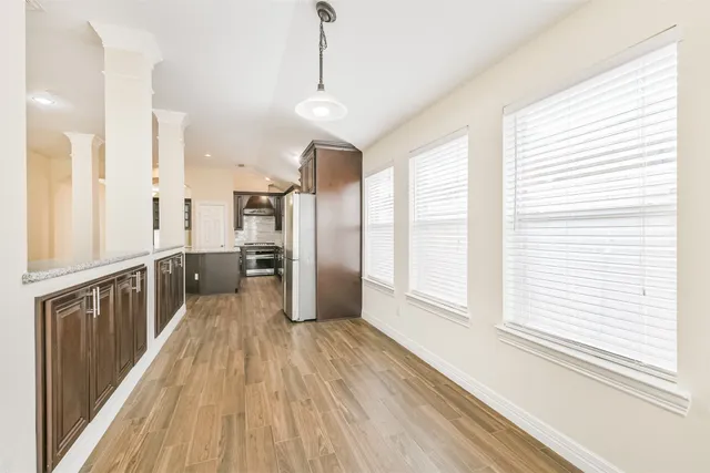 a spacious bathroom with a granite countertop sink mirror and bathtub