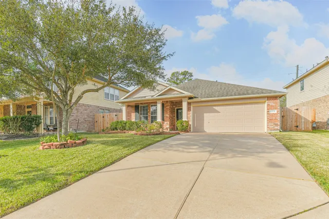 a front view of a house with a yard and trees