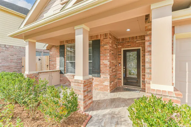 a view of a livingroom with wooden floor and a ceiling fan