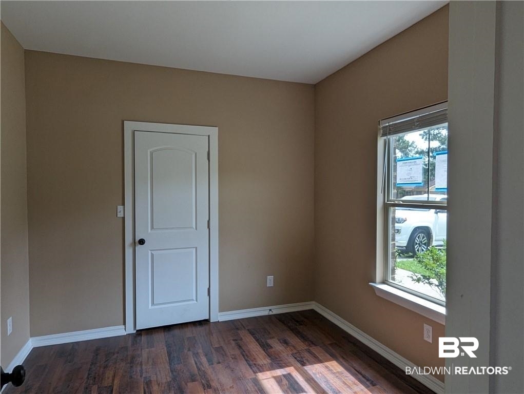 659 Bond Street Mobile, AL 36607 - Photo 8 of 10 Unfurnished room featuring dark hardwood / wood-style floors