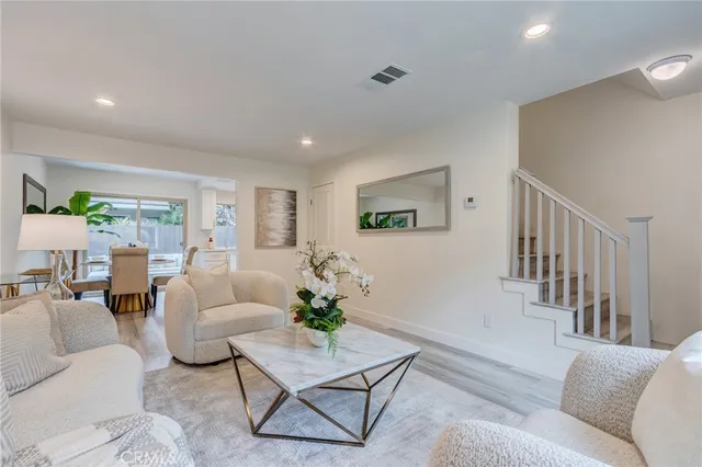 a dining room with furniture a window and wooden floor
