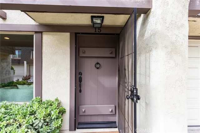 a kitchen with white cabinets and window
