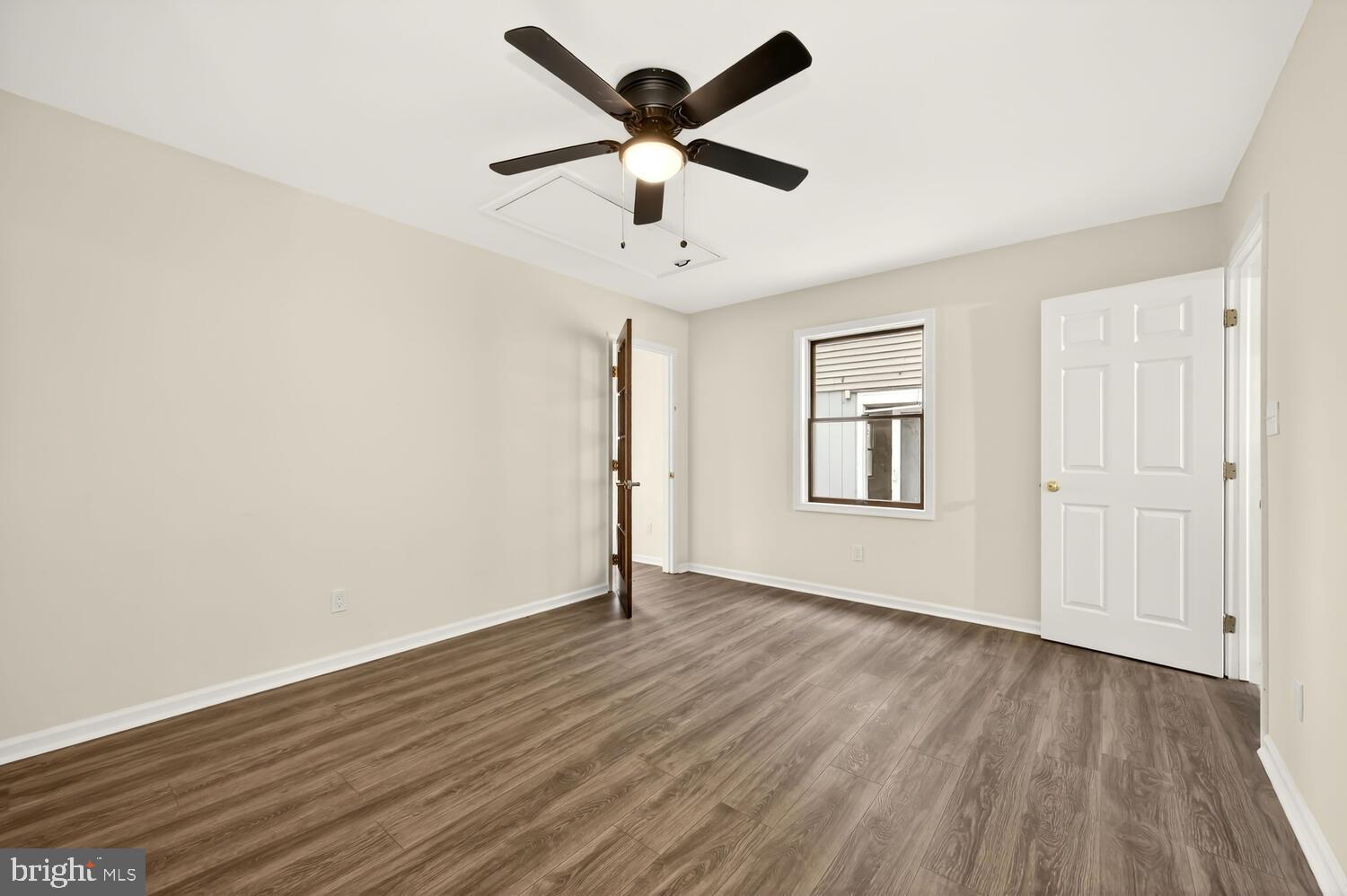 6746 Quaker Neck Road Chestertown, MD 21620 - Photo 39 of 50 a view of an empty room with window and wooden floor