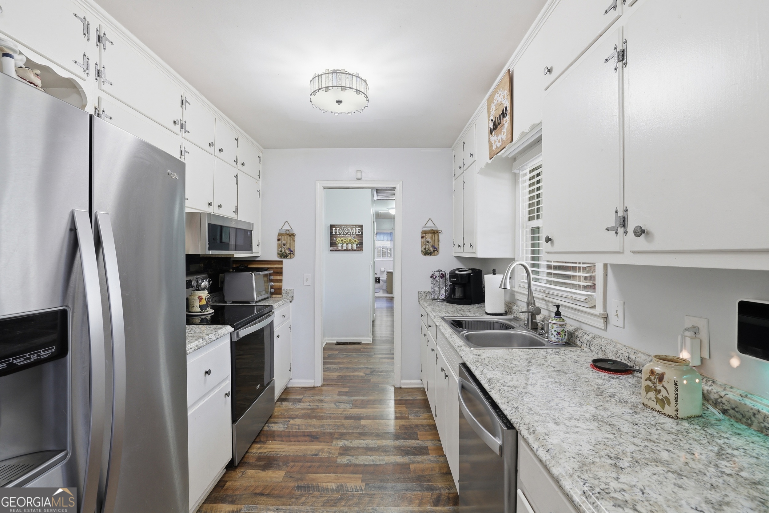 326 Remsdale Road Toccoa, GA 30577 - Photo 9 of 37 a kitchen with stainless steel appliances granite countertop a refrigerator a stove and a sink with wooden floor