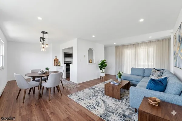 a living room with furniture and wooden floor