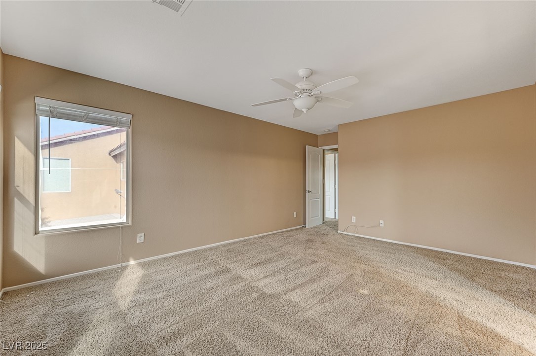83 Lockheed Avenue Las Vegas, NV 89183 - Photo 17 of 28 Empty room featuring carpet flooring and a ceiling fan