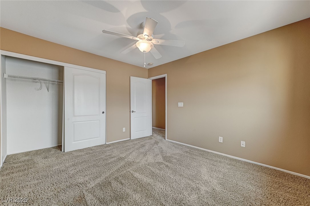 83 Lockheed Avenue Las Vegas, NV 89183 - Photo 19 of 28 Unfurnished bedroom featuring a closet, carpet, and ceiling fan