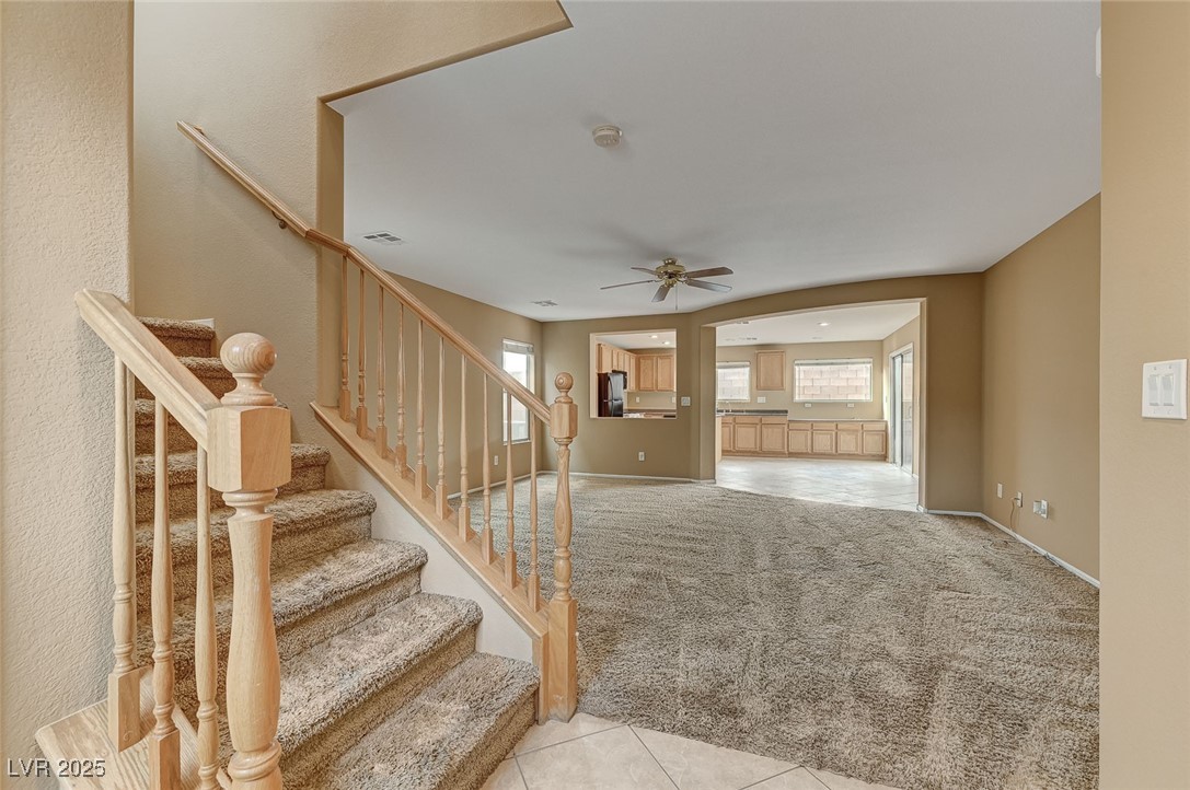 83 Lockheed Avenue Las Vegas, NV 89183 - Photo 2 of 28 Stairs with carpet flooring, healthy amount of natural light, tile patterned floors, and ceiling fan