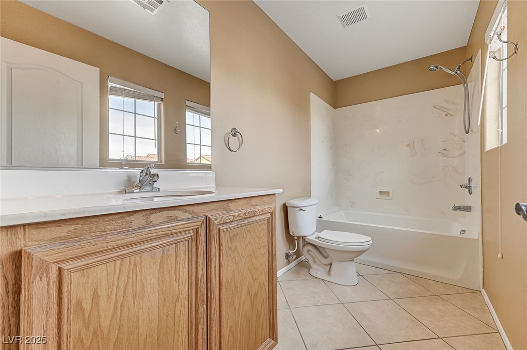 83 Lockheed Avenue Las Vegas, NV 89183 - Photo 24 of 28 Full bathroom with light tile patterned floors, vanity, and washtub / shower combination