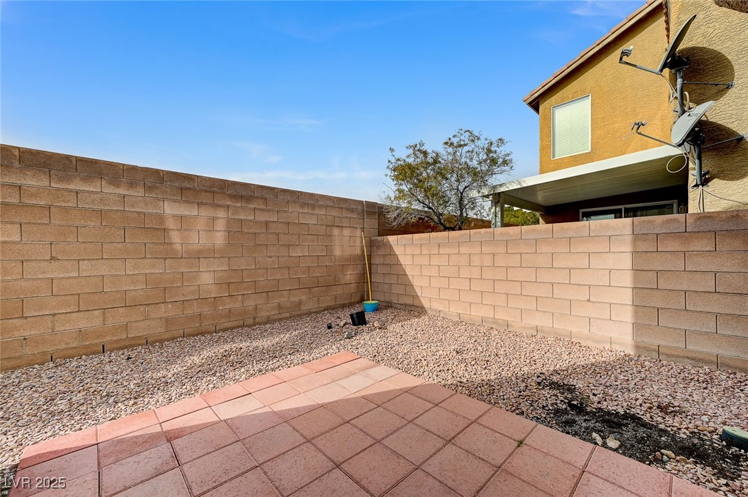 83 Lockheed Avenue Las Vegas, NV 89183 - Photo 25 of 28 Fenced backyard featuring a patio area