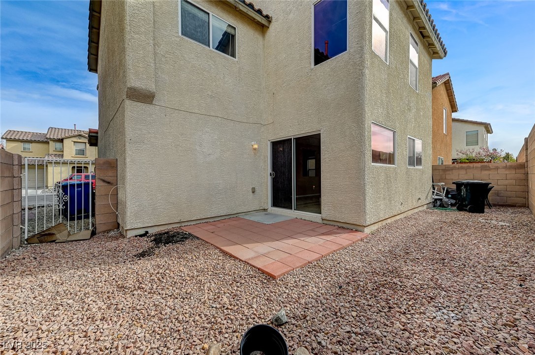 83 Lockheed Avenue Las Vegas, NV 89183 - Photo 27 of 28 Rear view of property with a fenced backyard, a patio, stucco siding, and a gate