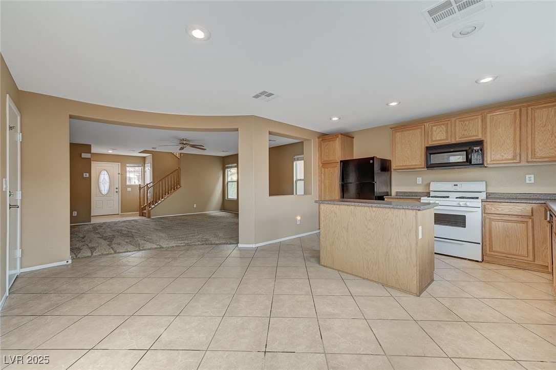 83 Lockheed Avenue Las Vegas, NV 89183 - Photo 28 of 28 Kitchen featuring a kitchen island, black appliances, light tile patterned floors, open floor plan, and recessed lighting