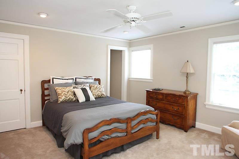 2400 White Oak Road Raleigh, NC 27609 - Photo 14 of 20 a bedroom with a bed and a chandelier