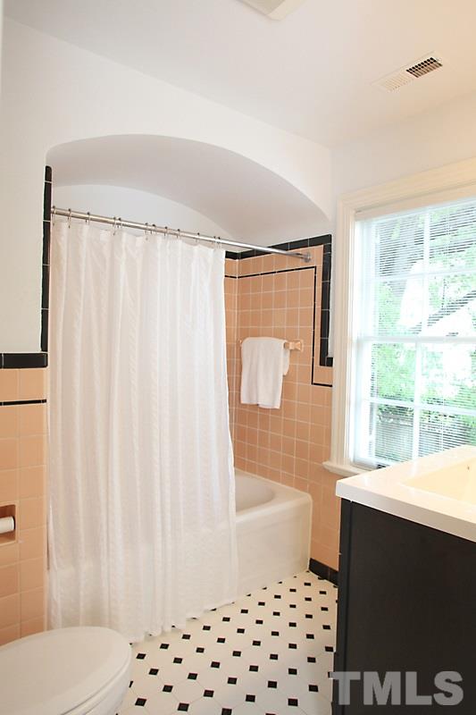 2400 White Oak Road Raleigh, NC 27609 - Photo 15 of 20 a bathroom with a sink a toilet a window and shower