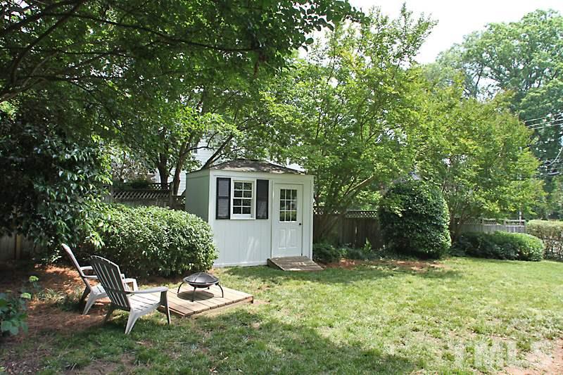 2400 White Oak Road Raleigh, NC 27609 - Photo 18 of 20 a backyard of a house with table and chairs