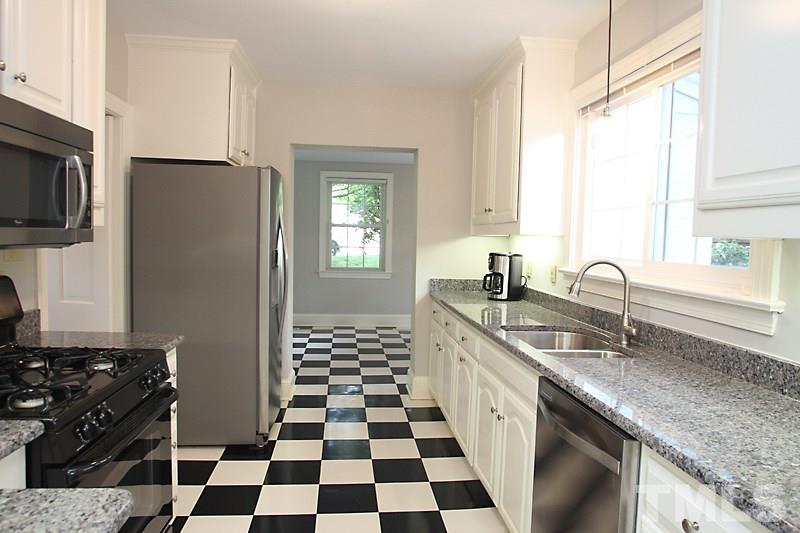 2400 White Oak Road Raleigh, NC 27609 - Photo 5 of 20 a kitchen with a sink a stove and a refrigerator