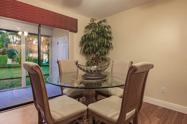 a dining room with furniture and wooden floor