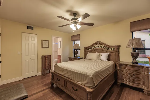 a bedroom with a large bed and a chandelier