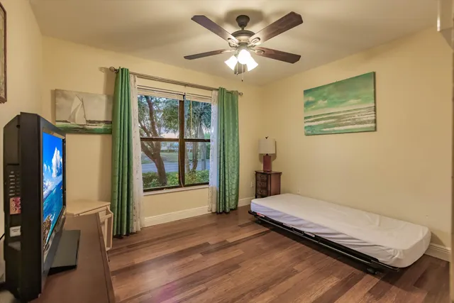 a bedroom with furniture and a flat screen tv