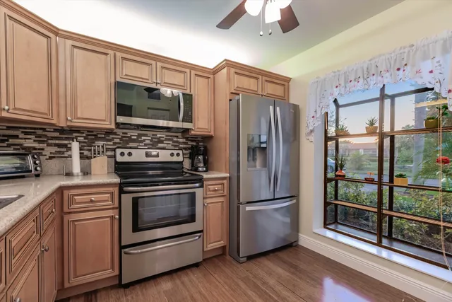 a kitchen with stainless steel appliances and wooden cabinets