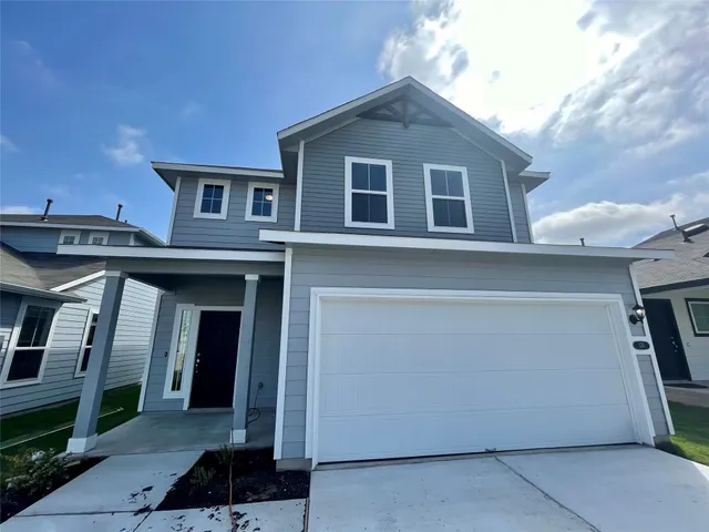 a front view of a house with garage