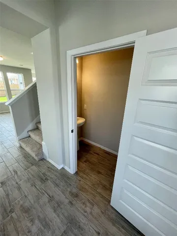 a view of entryway with wooden floor and stairs