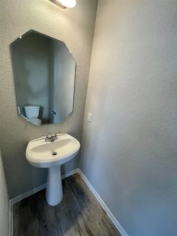 a bathroom with a sink toilet and mirror