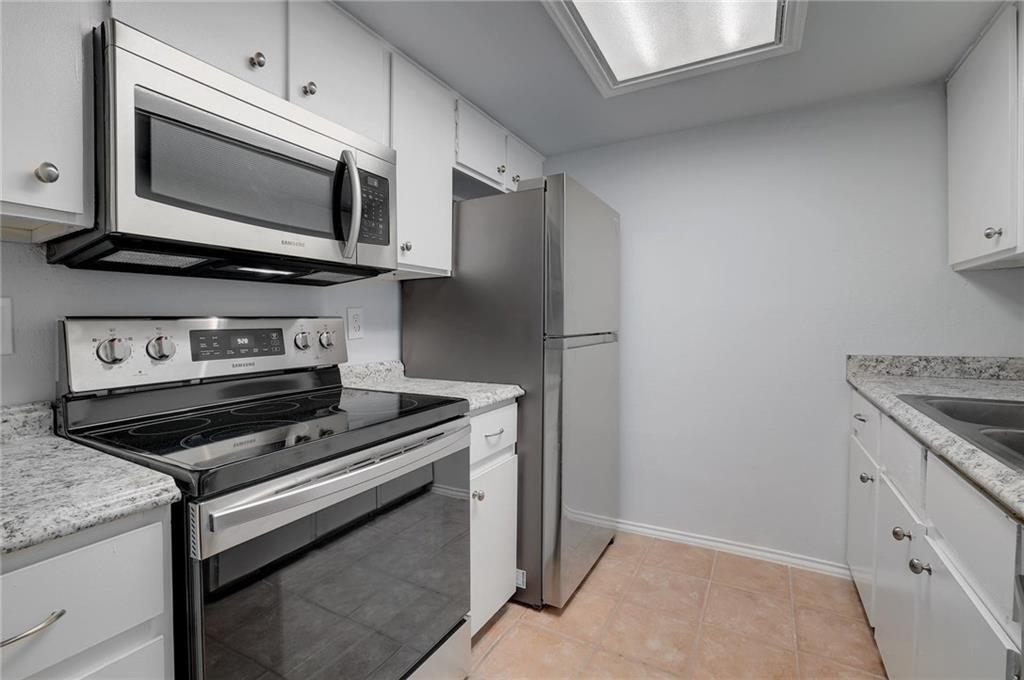 2401 Leon Street, Unit 201 Austin, TX 78705 - Photo 2 of 13 a kitchen with a stove microwave and sink