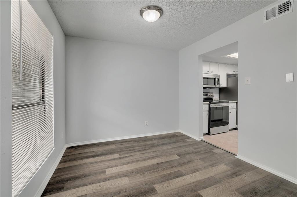 2401 Leon Street, Unit 201 Austin, TX 78705 - Photo 3 of 13 an empty room with windows and entrance