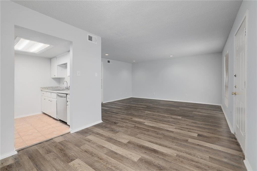 2401 Leon Street, Unit 201 Austin, TX 78705 - Photo 4 of 13 a view of empty room with wooden floor