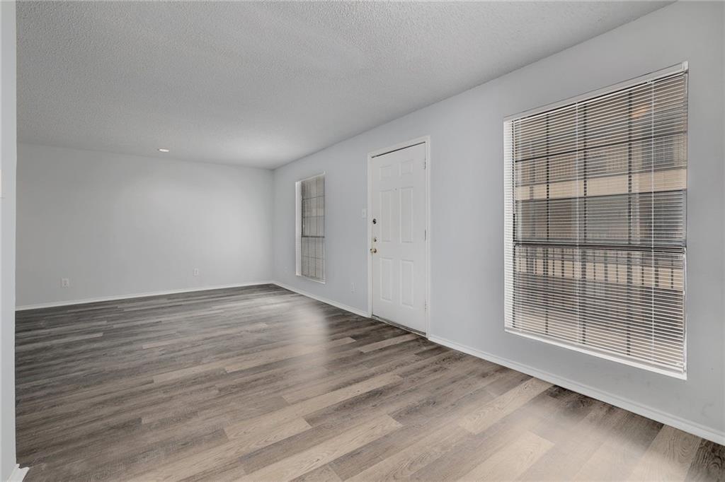 2401 Leon Street, Unit 201 Austin, TX 78705 - Photo 5 of 13 a view of an empty room with wooden floor and a window