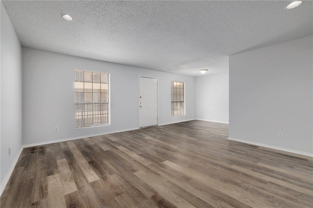 2401 Leon Street, Unit 201 Austin, TX 78705 - Photo 6 of 13 a view of an empty room with wooden floor and a window