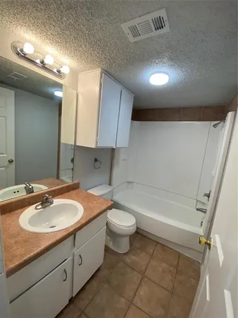 a bathroom with a sink a toilet a mirror and bathtub