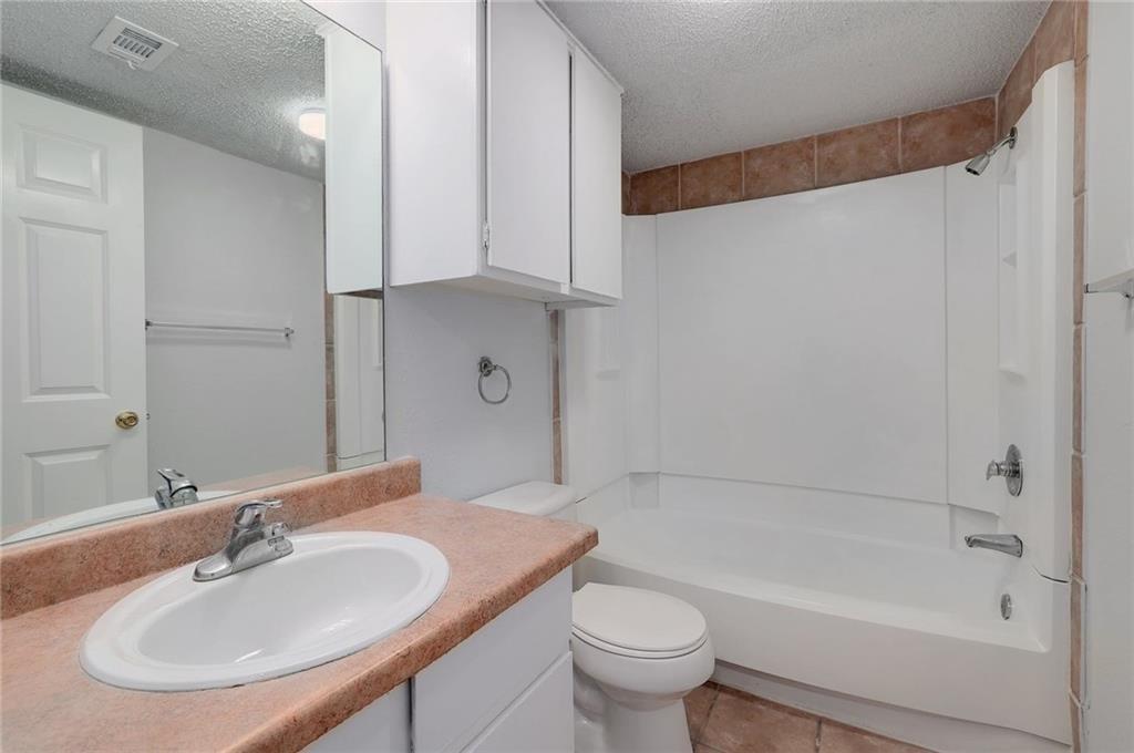 2401 Leon Street, Unit 201 Austin, TX 78705 - Photo 10 of 13 a bathroom with a sink and a mirror