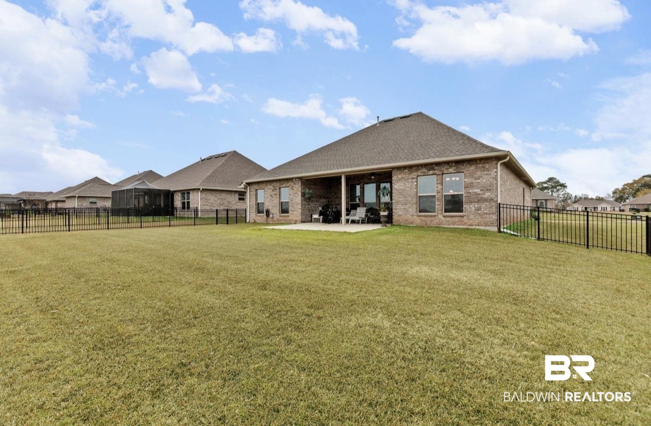 10126 Chipper Lane Foley, AL 36535 - Photo 27 of 30 Rear view of property with brick siding, a patio, a fenced backyard, and a shingled roof