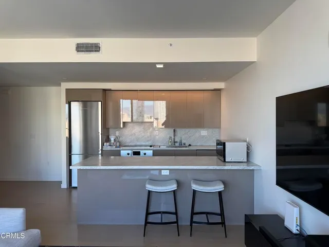 a bathroom with a sink a chair and a large mirror