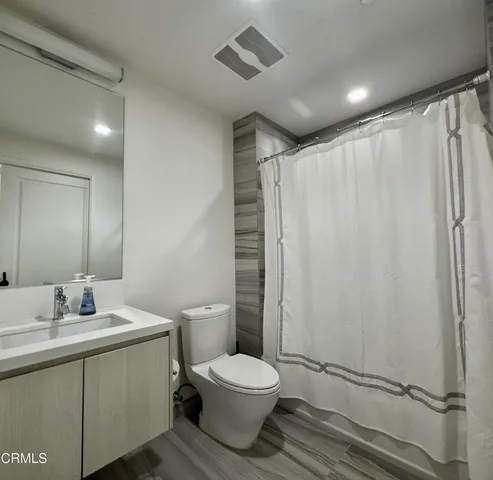 a bathroom with a toilet a sink and a shower