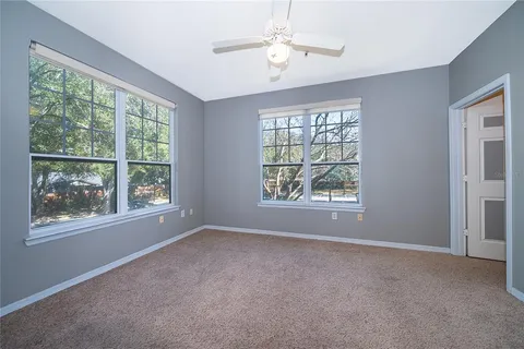 an empty room with windows and outdoor view