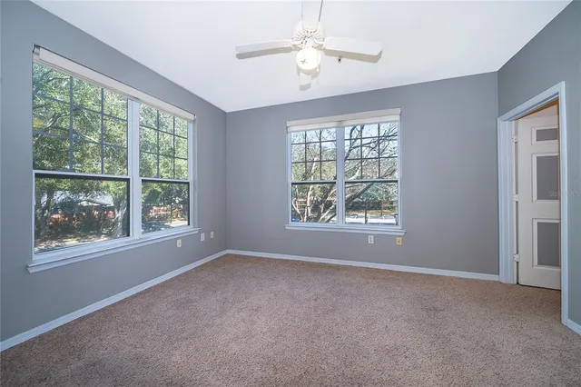 an empty room with windows and outdoor view